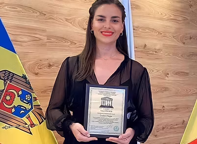 Liuba holding a performance award